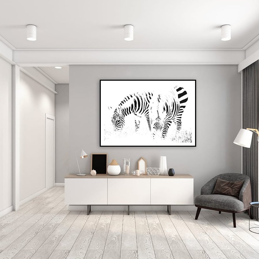 High-key black and white zebra photograph capturing two zebras grazing in perfect symmetry. A minimalist wildlife portrait focused on abstract patterns, contrast, and stillness.