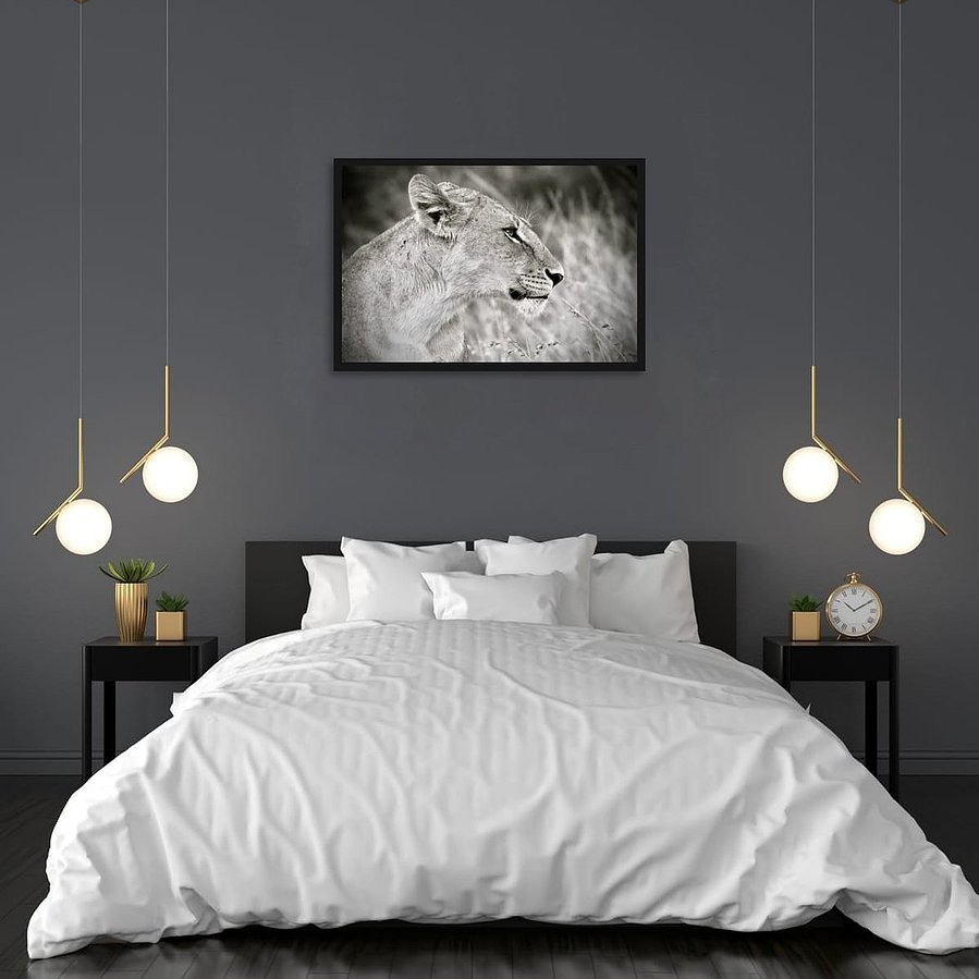 Striking black and white wildlife photograph of a lioness in side profile. Her powerful jawline, poised expression, and flowing mane are captured in dramatic detail, revealing the quiet strength and elegance of one of Africa’s most iconic predators.