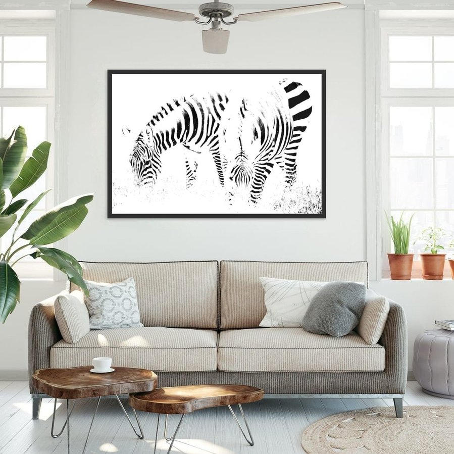 High-key black and white zebra photograph capturing two zebras grazing in perfect symmetry. A minimalist wildlife portrait focused on abstract patterns, contrast, and stillness.