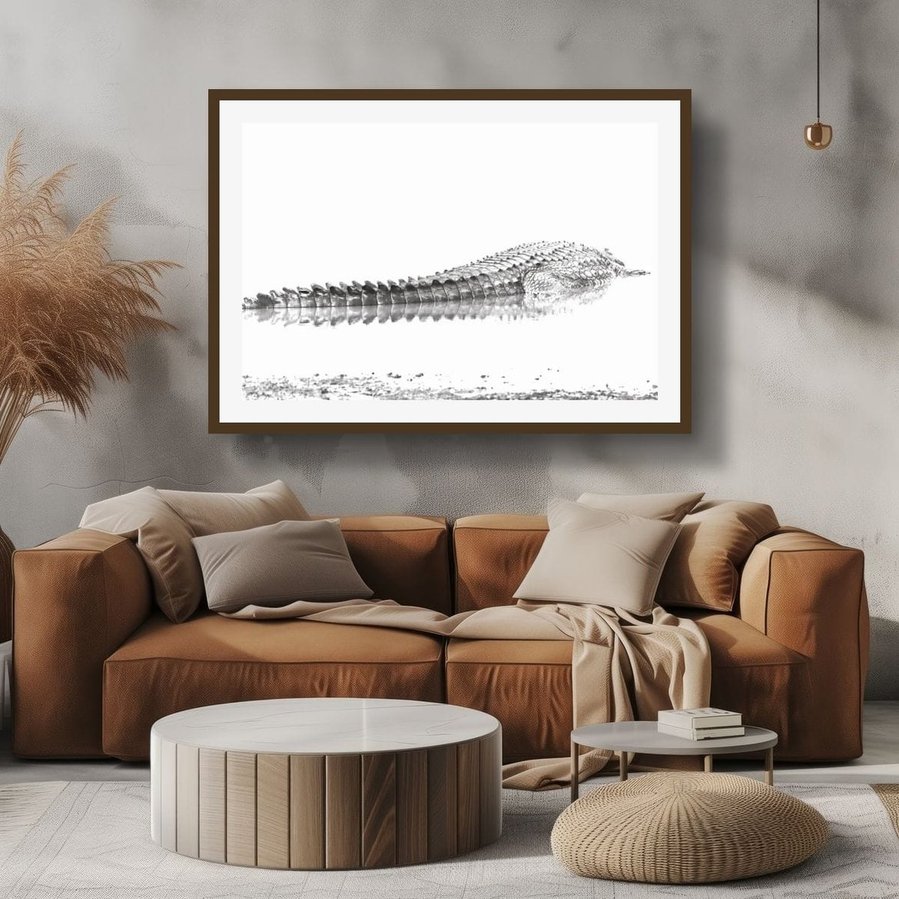 Overexposed black and white photograph of a Nile crocodile resting at the edge of a body of water. The dramatic lighting and minimal composition highlight the intricate textures and patterns of the crocodile’s scaly back creating a fine art wildlife image