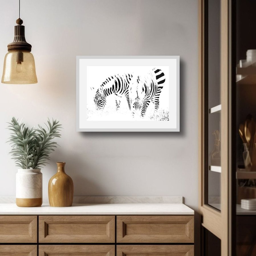 High-key black and white zebra photograph capturing two zebras grazing in perfect symmetry. A minimalist wildlife portrait focused on abstract patterns, contrast, and stillness.