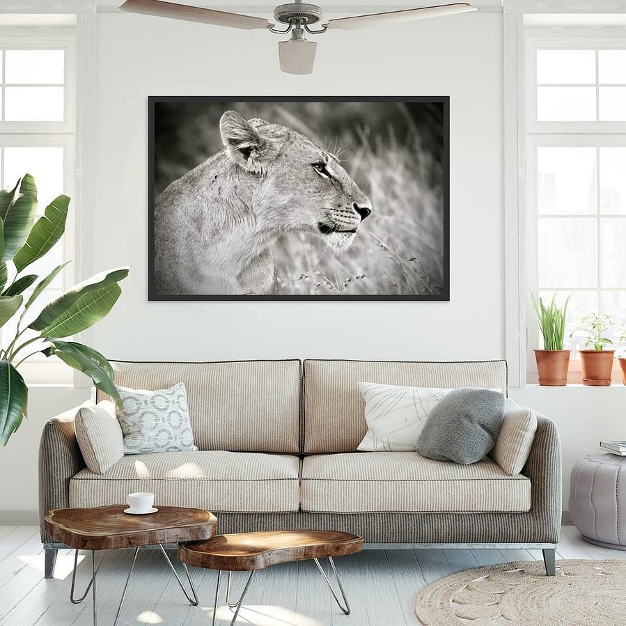 Striking black and white wildlife photograph of a lioness in side profile. Her powerful jawline, poised expression, and flowing mane are captured in dramatic detail, revealing the quiet strength and elegance of one of Africa’s most iconic predators.