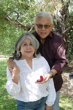 50th wedding anniversary couple posing together with ring in box. 