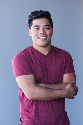 Male in purple shirt smiling, portrait photography. 
