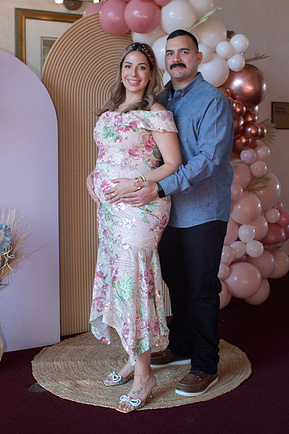 Mom and dad posing at a baby shower. 