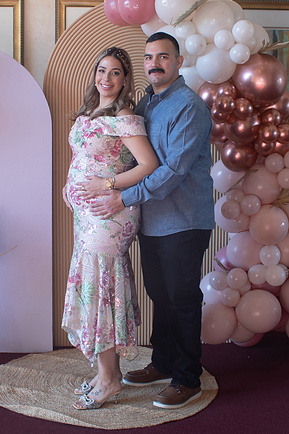 A photograph of mom and dad at a baby shower, a maternity photograph. 