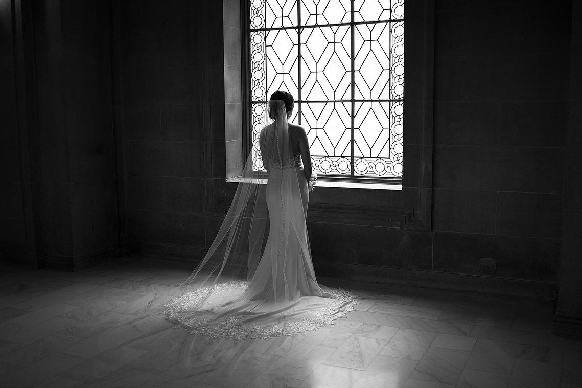 Black and white bridal portrait in front of a window. 