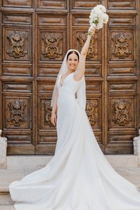 Bride with bouquet after the ceremony in cathedral Ostuni