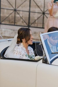 Bride in a wedding car after the ceremony at Monopoli