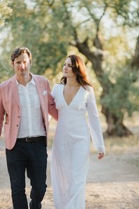 Couple walking through the olive garden in Puglia after ceremony