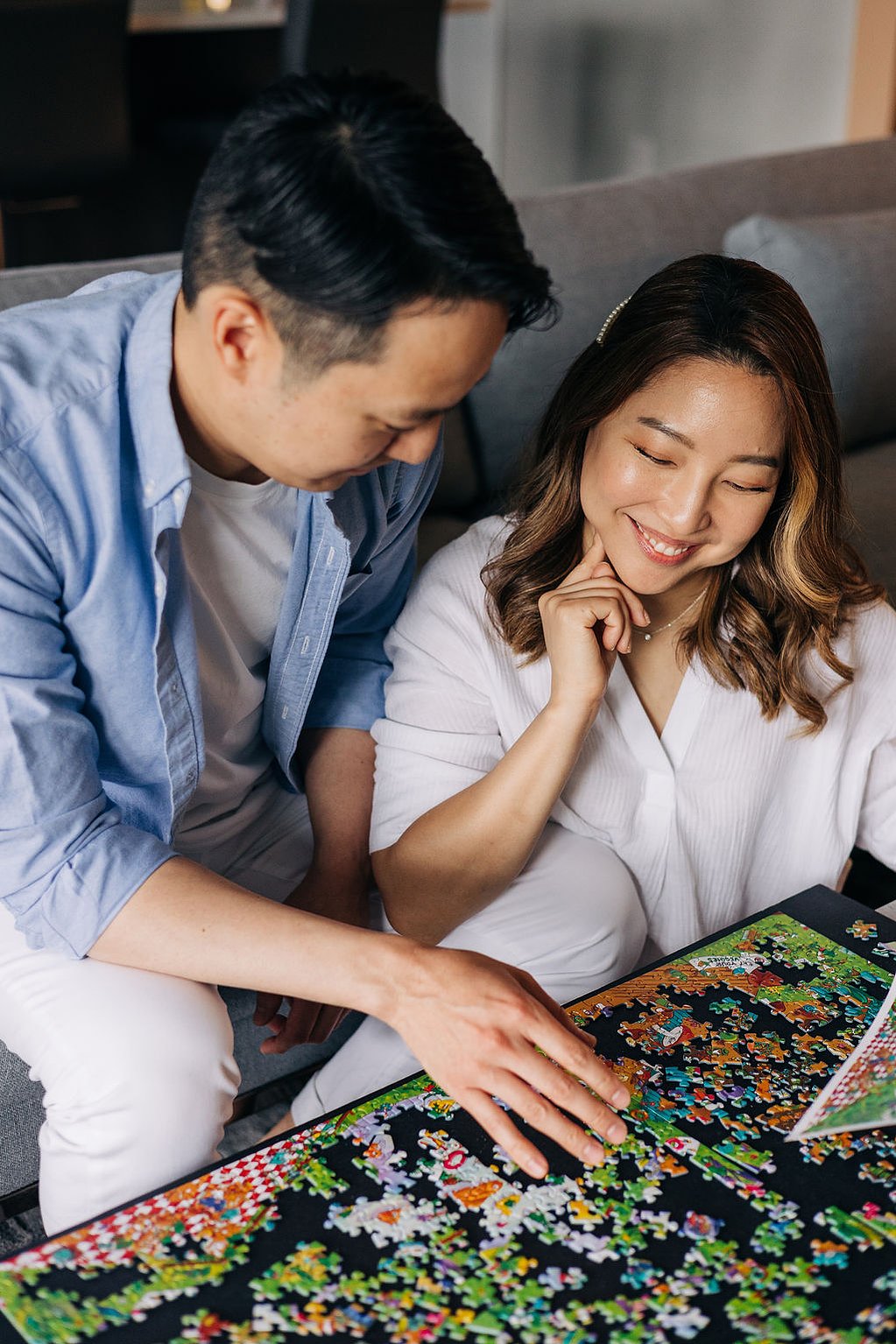 documentary style engagement photoshoot at home in the philadelphia suburbs couple doing puzzles