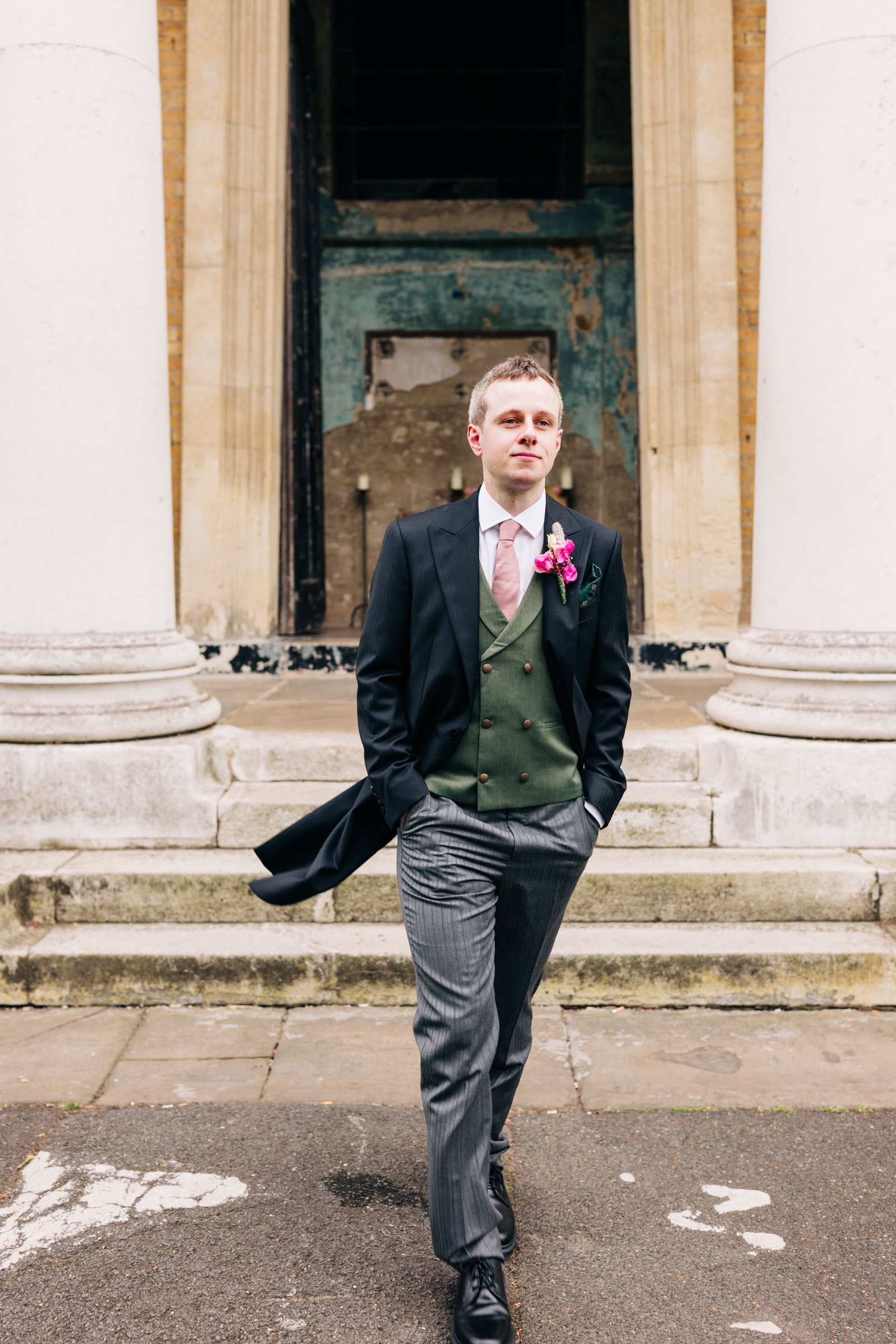Groom portrait London wedding at Asylum Chapel wearing Moss Bros UK Suit and Doc Martens Shoes