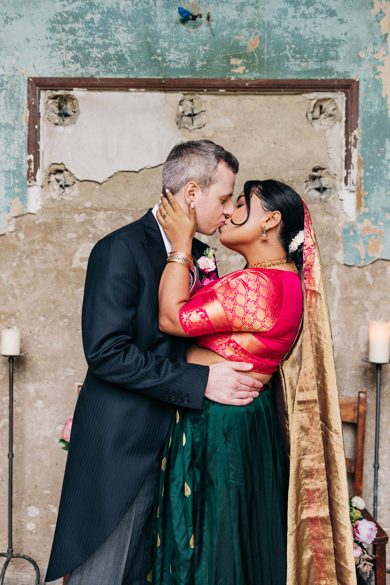 colorful multicultural british indian wedding at asylum chapel in london england UK wedding bride wearing hot pink and emerald green sari from nalli silks groom wearing suit from moss bros