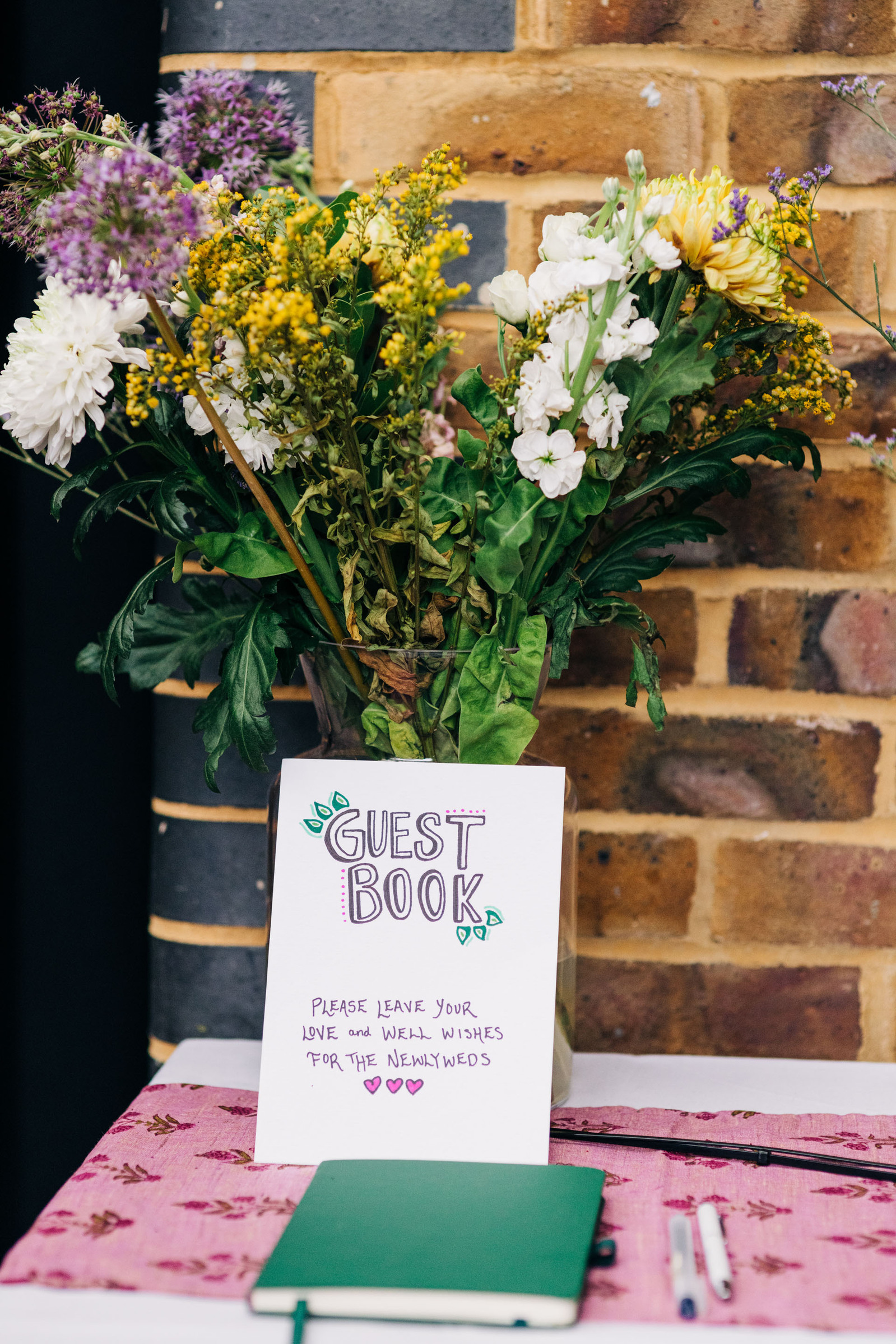 amp studios london wedding reception party dinner featuring pink and green wedding decor inspiration guest book