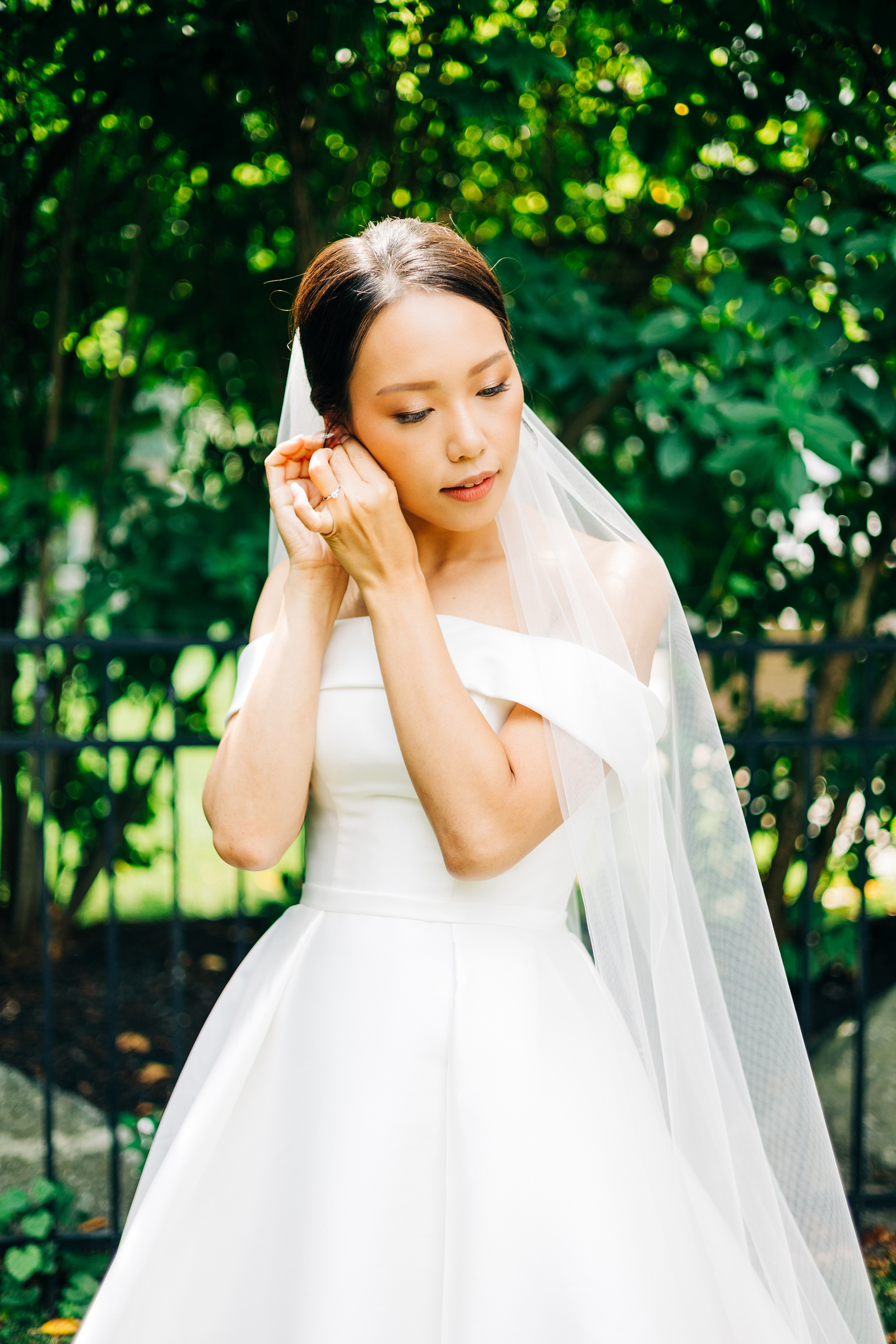 bride putting on jewelry before her wedding