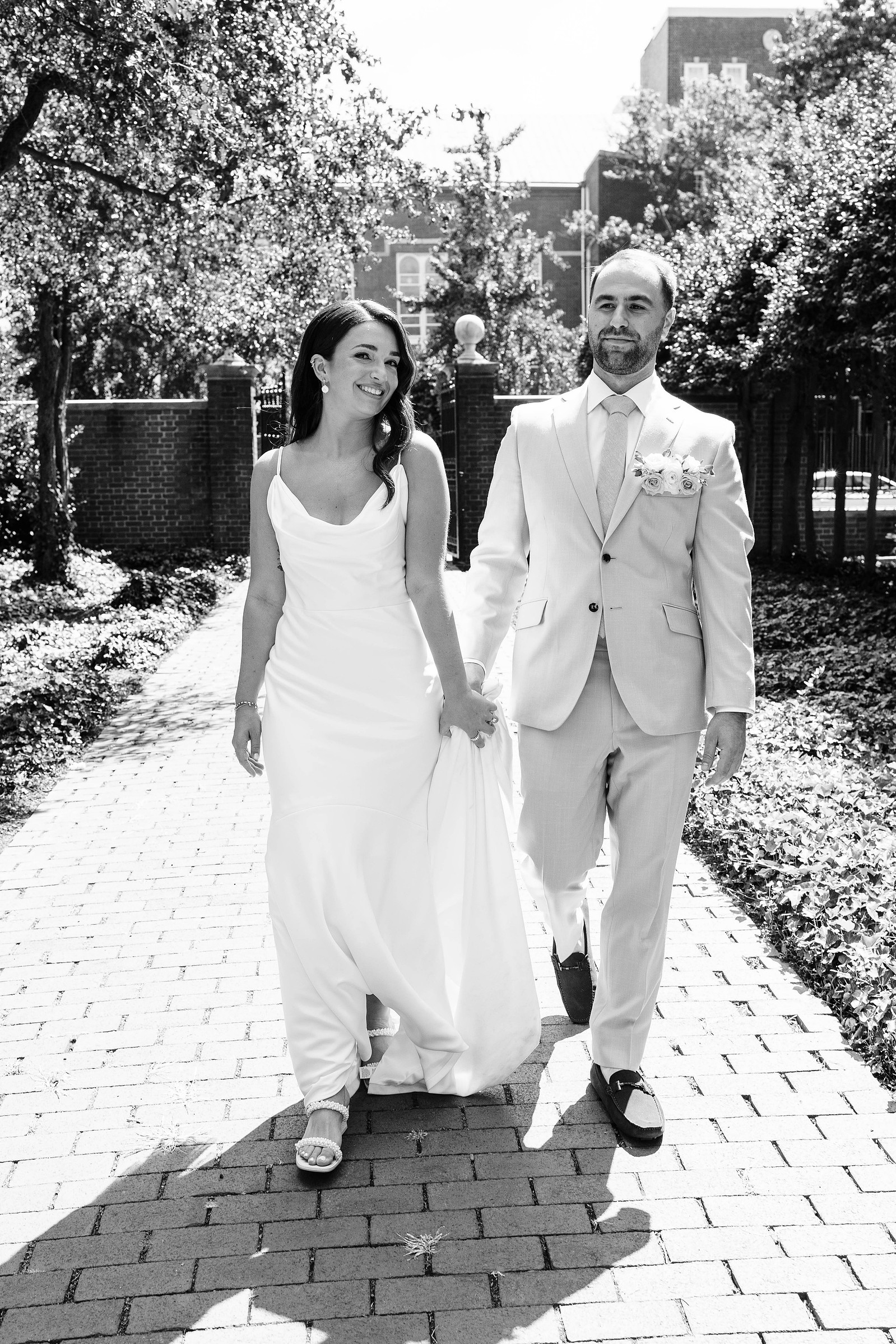 black and white candid wedding photography of bride and groom walking in downtown old city philadelphia