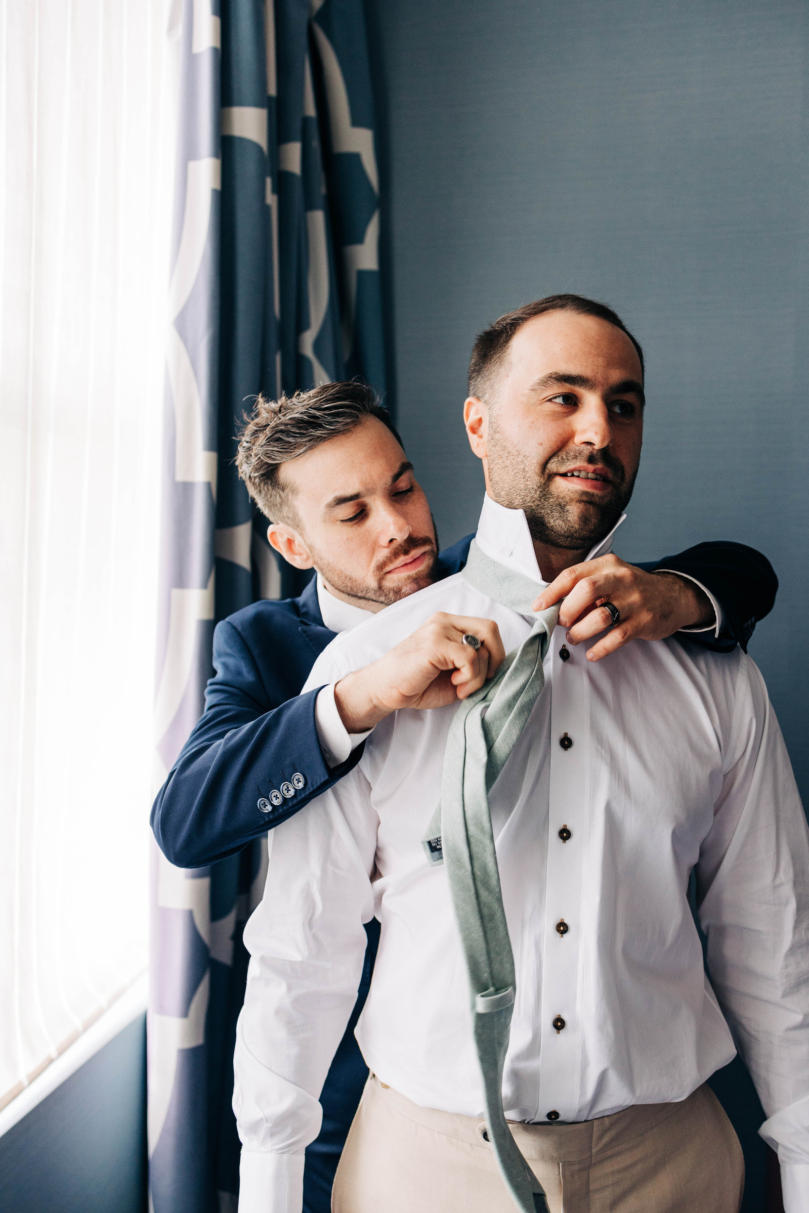groom getting ready with best man on his wedding day at hotel monaco philadelphia