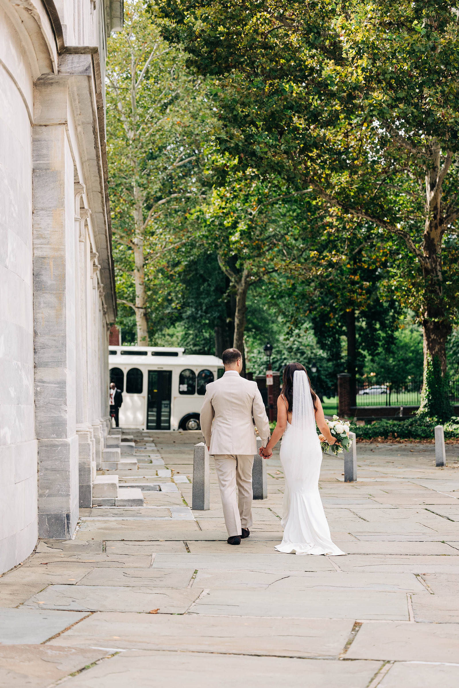 bride and groom candid photo walking in old city philadelphia