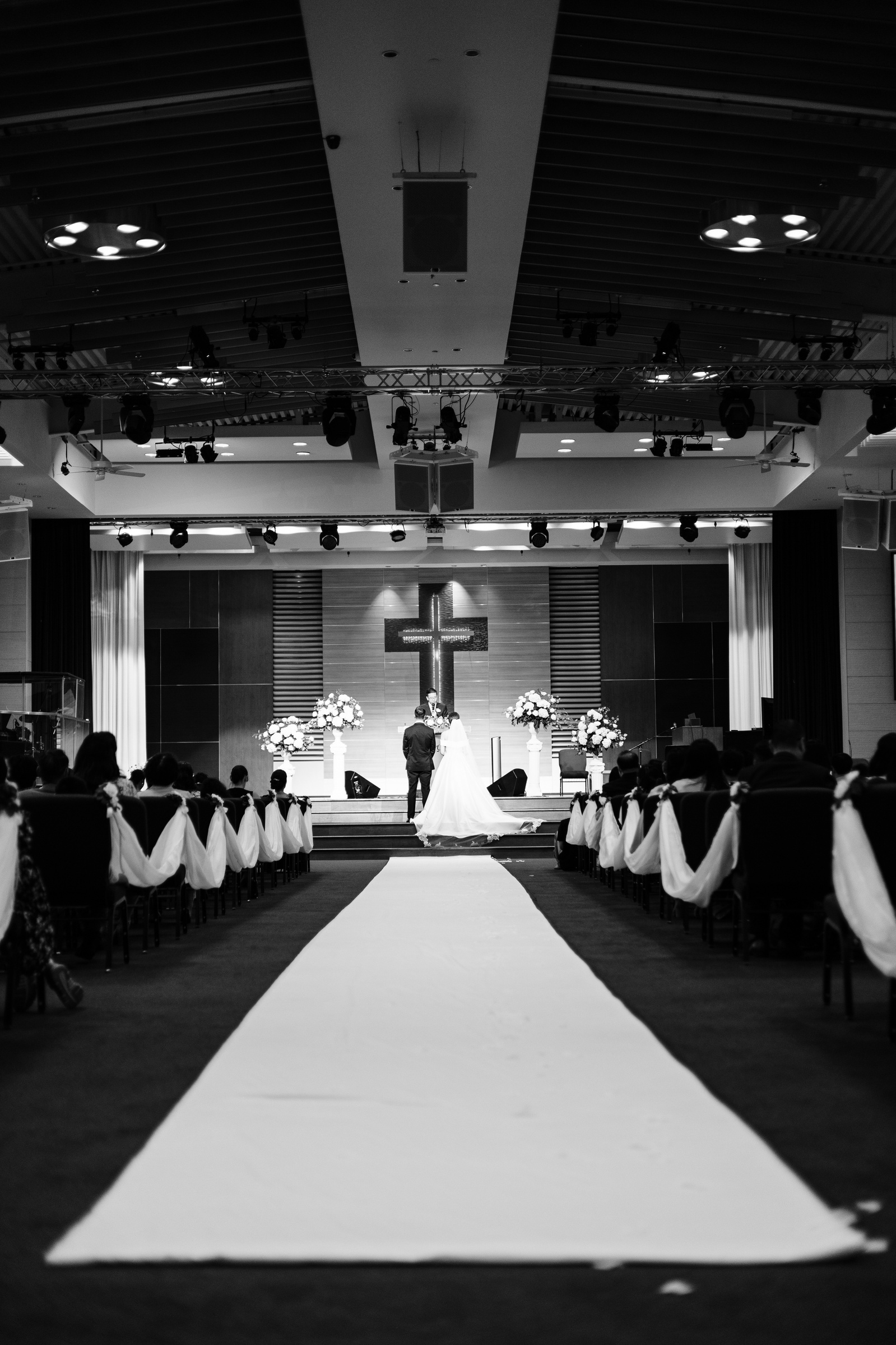 black and white wide photo of wedding altar at a church