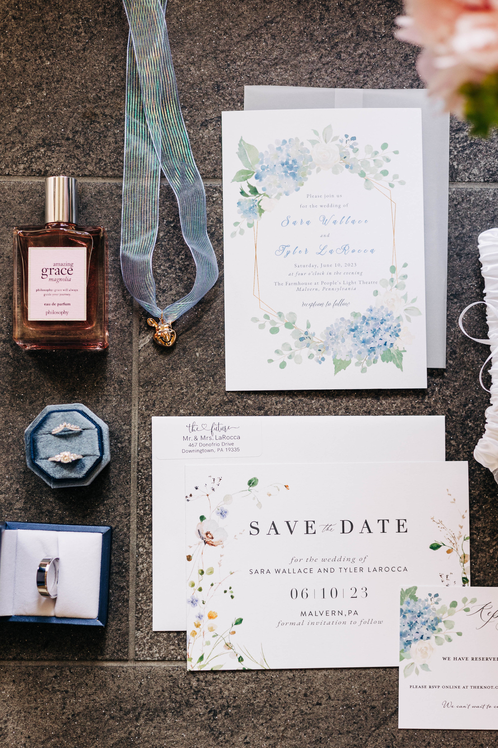 bridal lay flat of wedding day details featuring pastel blue and pink colors