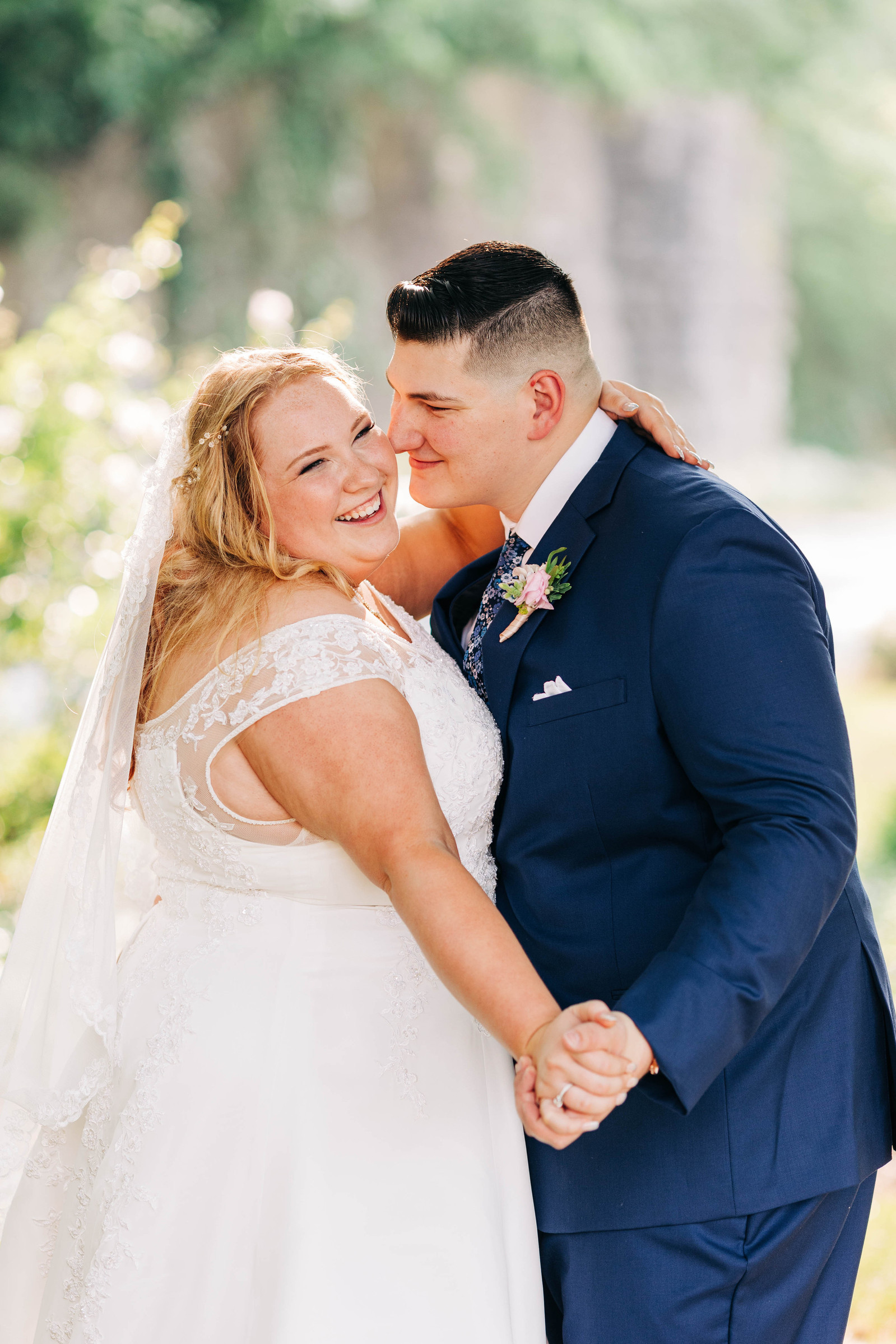 bride and groom dancing and smiling in warm sunlight