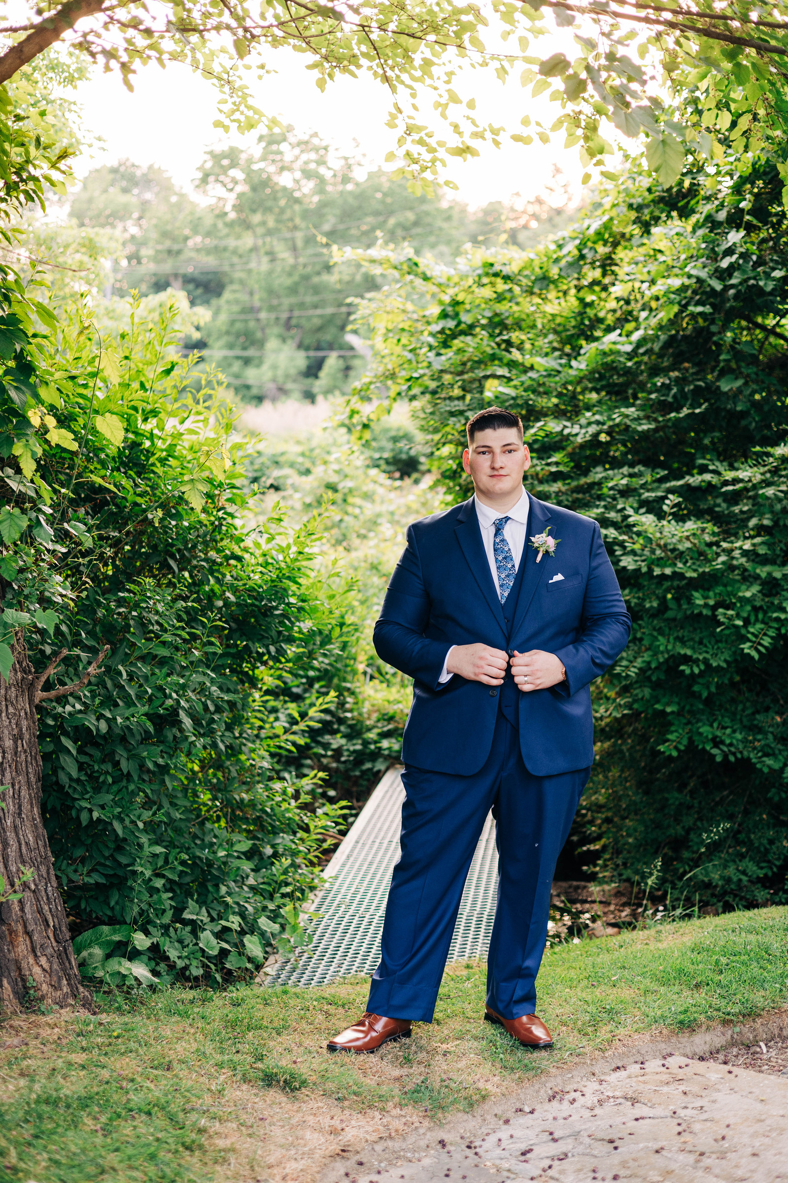 golden hour portrait of groom at the farmhouse at people's light theater in malvern pennsylvania wedding