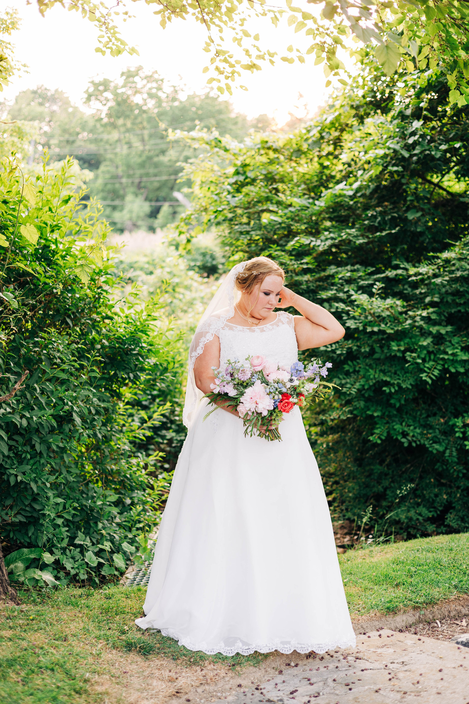 golden hour portrait of bride on her wedding day in the garden at the farmhouse at people's light theater in malvern pennsylvania