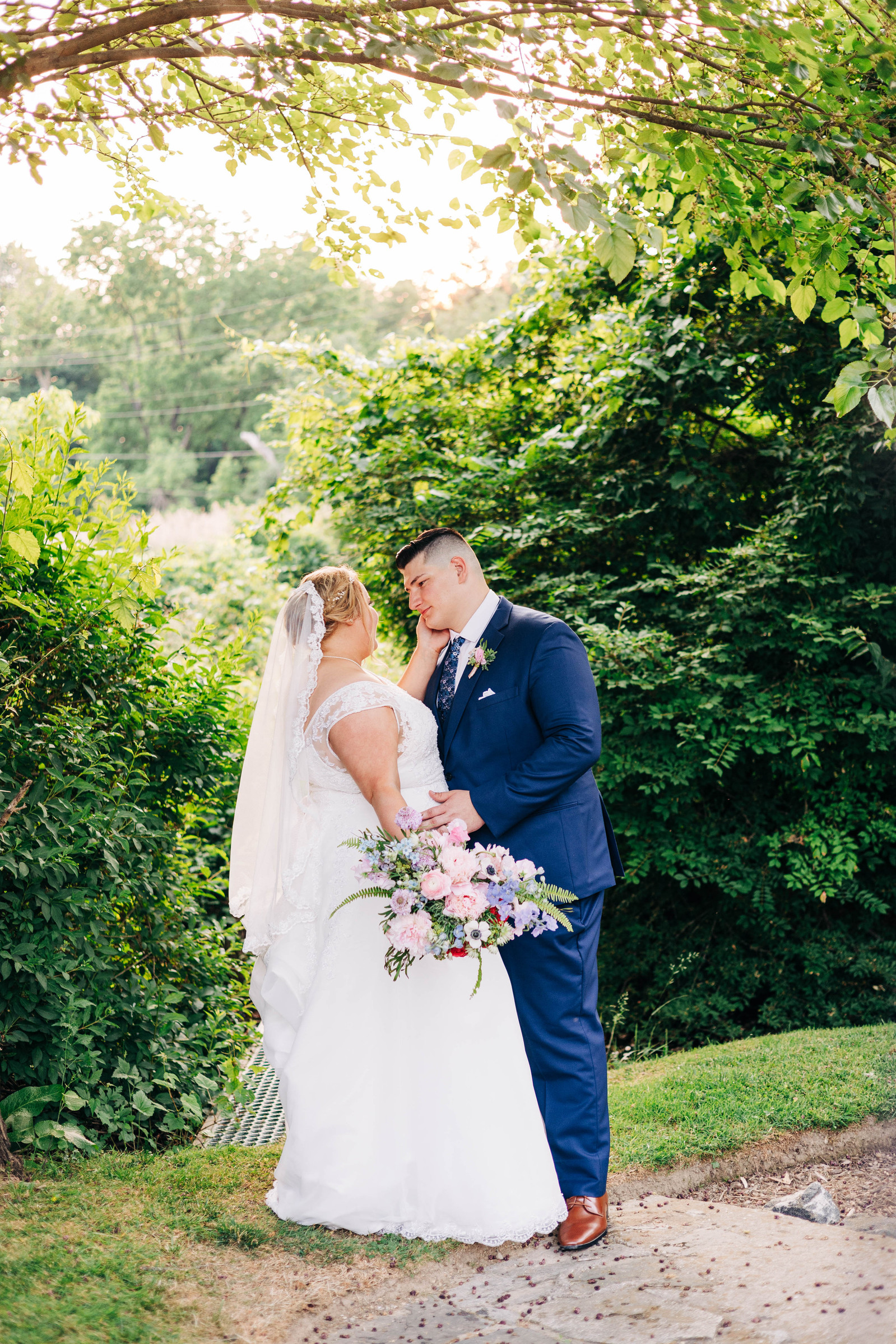 bride and groom during golden hour in the gardens at the farmhouse at people's light theater in malvern pennsylvania on their wedding day 