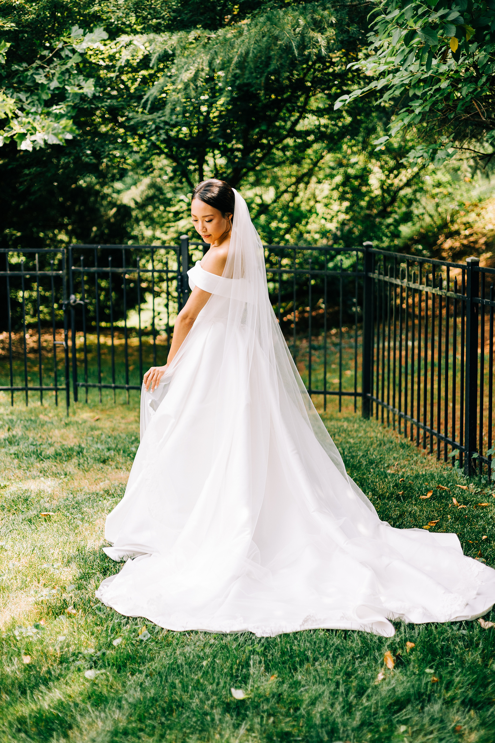 bridal portrait on her wedding day outside in a garden with warm golden light