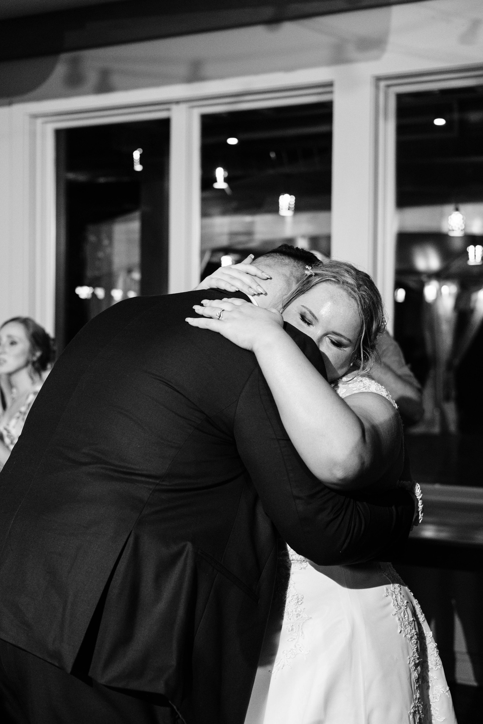 black and white photo of bride and groom slow dancing during their wedding reception 