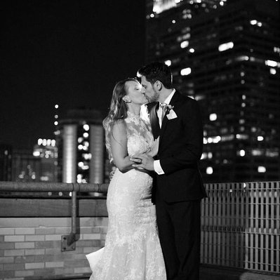 black and white rooftop night time portrait of bride and groom