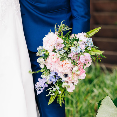 wedding flowers by grapewood florals featuring pink and blue colors with green ferns at the people's light theater in malvern PA