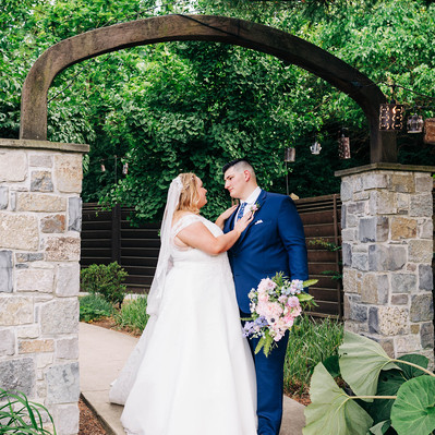 Portrait of bride and groom during golden hour on their wedding day at the Farmhouse at People's Light Theater in Malvern PA near Philadelphia
