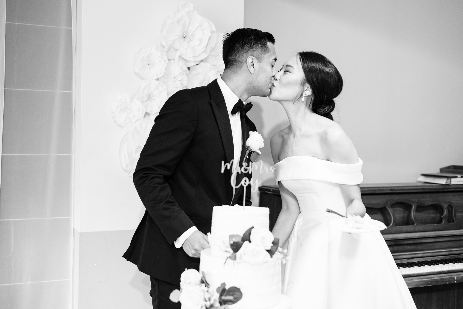 bride and groom kiss during their cake cutting