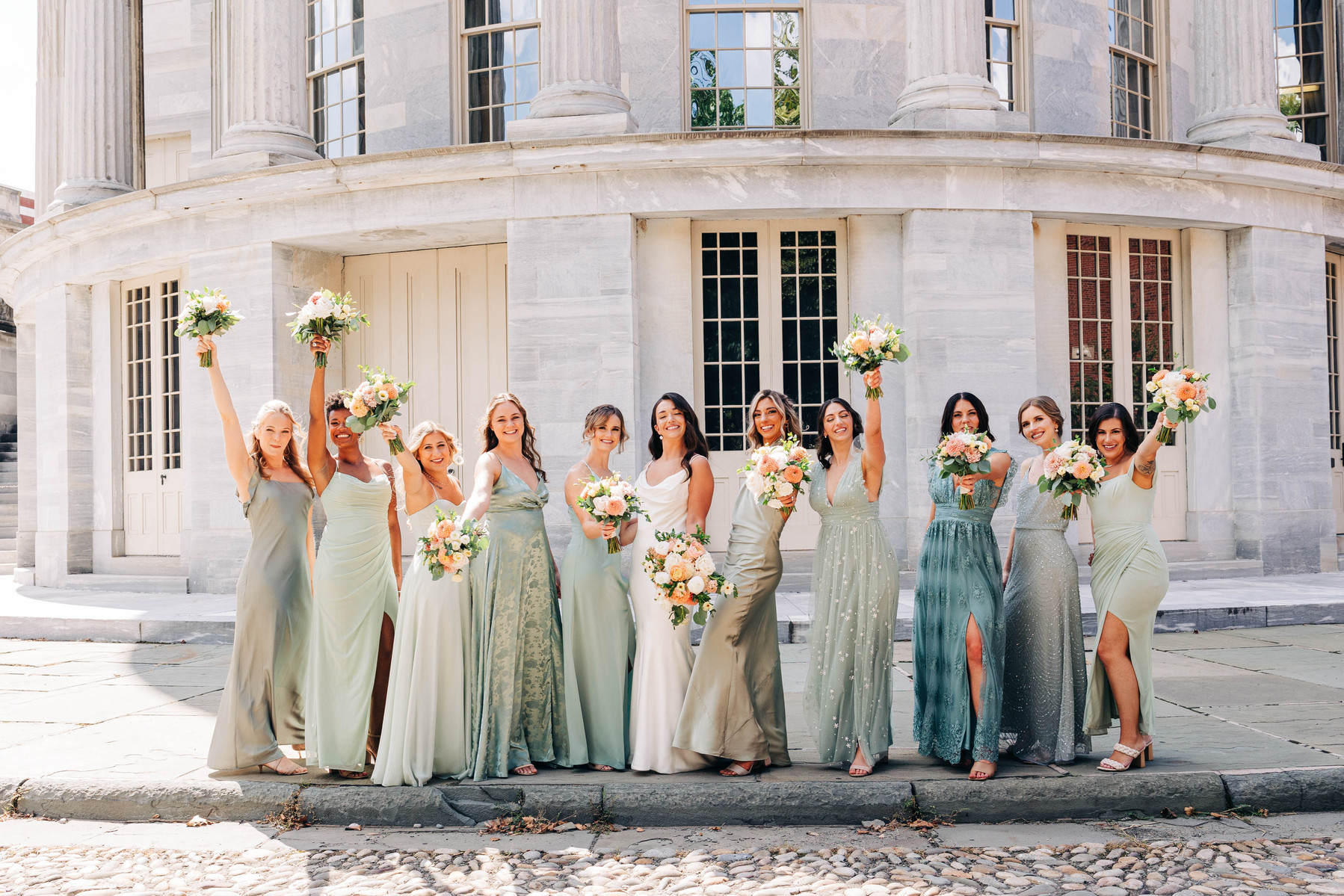 candid group photo of bridesmaids with bride on wedding day at the merchant's exchange building in philadelphia for a cescaphe wedding