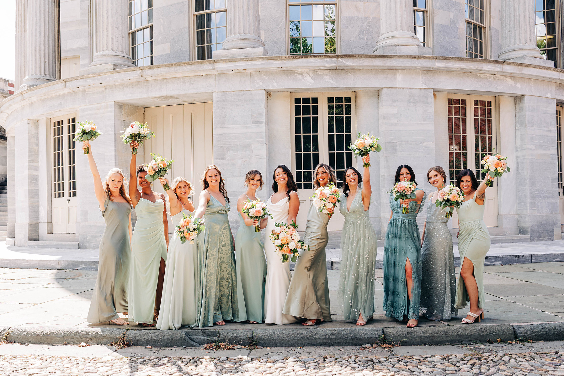 candid group photo of bridesmaids with bride on wedding day at the merchant's exchange building in philadelphia for a cescaphe wedding