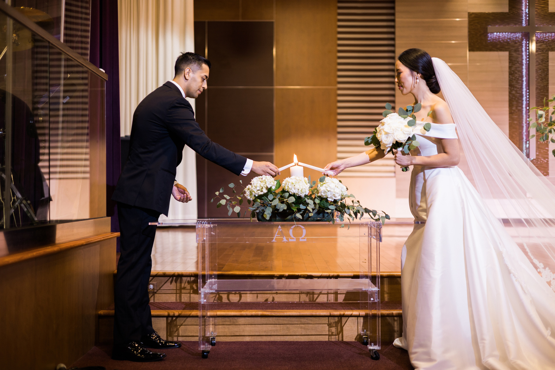 bride and groom light a unity candle during their wedding ceremony