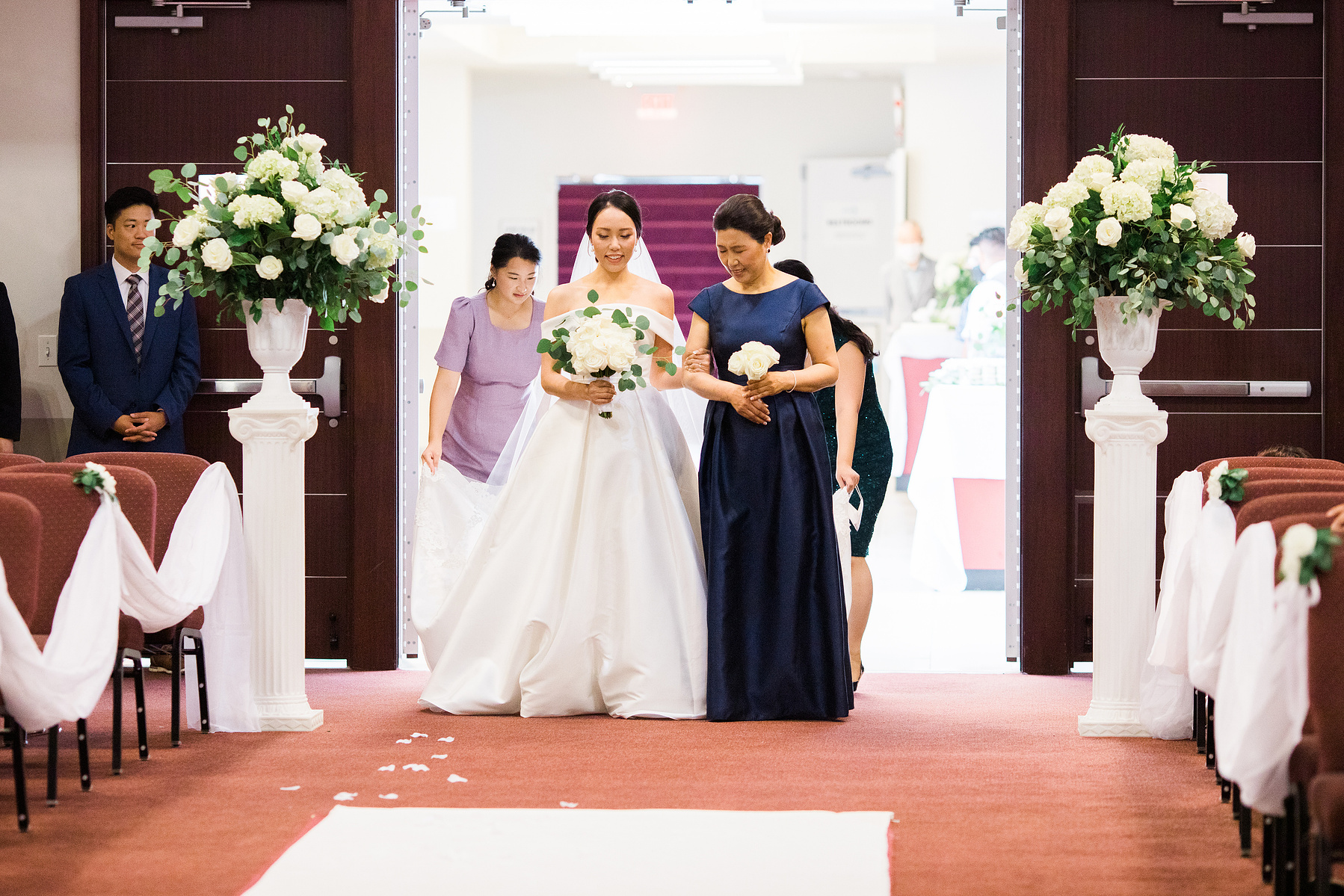 bride walking down the aisle with her mom