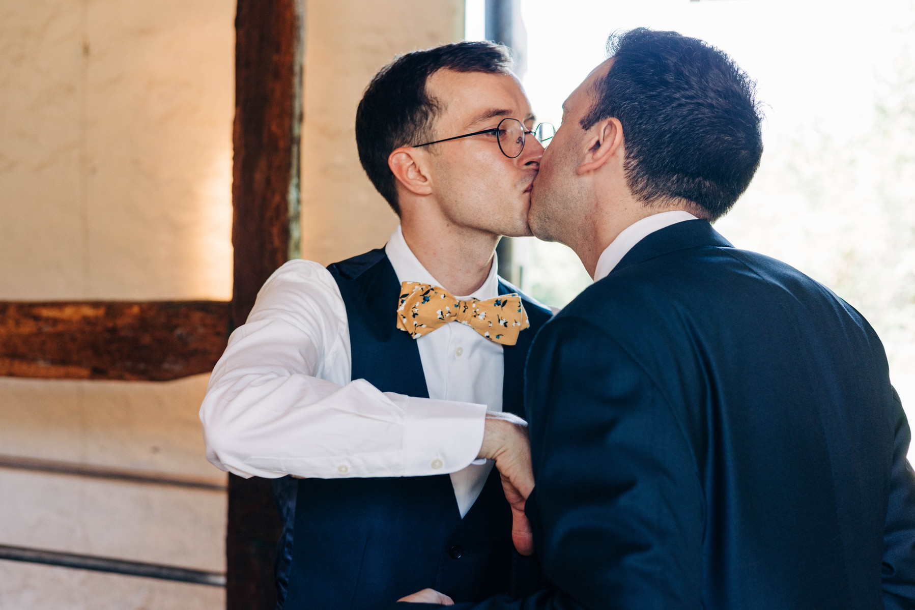 two grooms getting ready together on their wedding day in the suite at bartram's garden in philadelphia