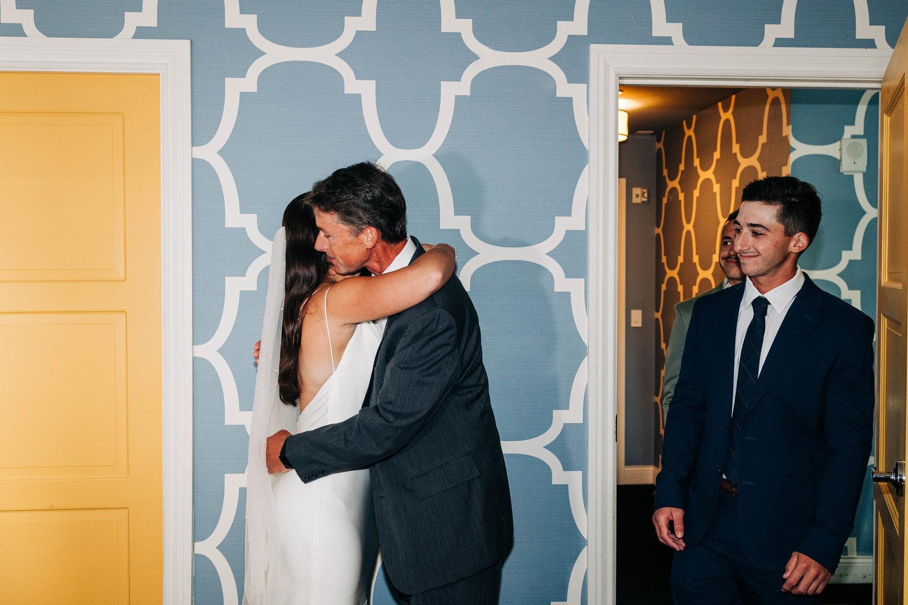 first look of bride getting ready with her dad and brothers on wedding day at hotel monaco philadelphia