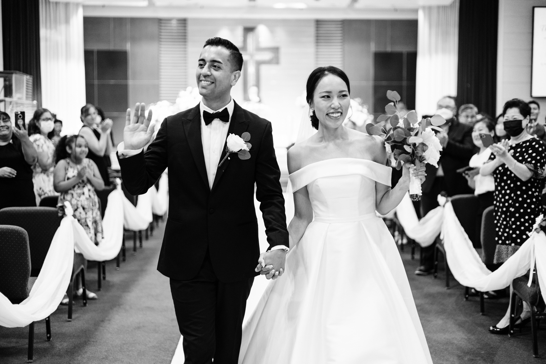 bride and groom walk down the aisle for first time as husband and wife after getting married