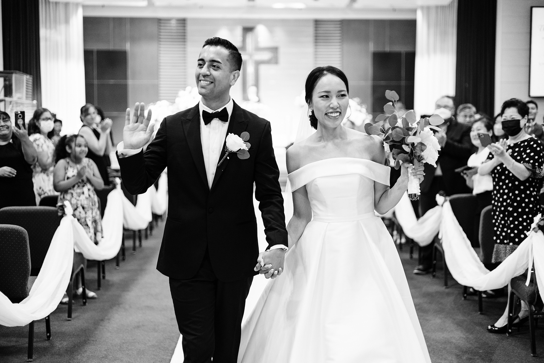 bride and groom walk down the aisle for first time as husband and wife after getting married