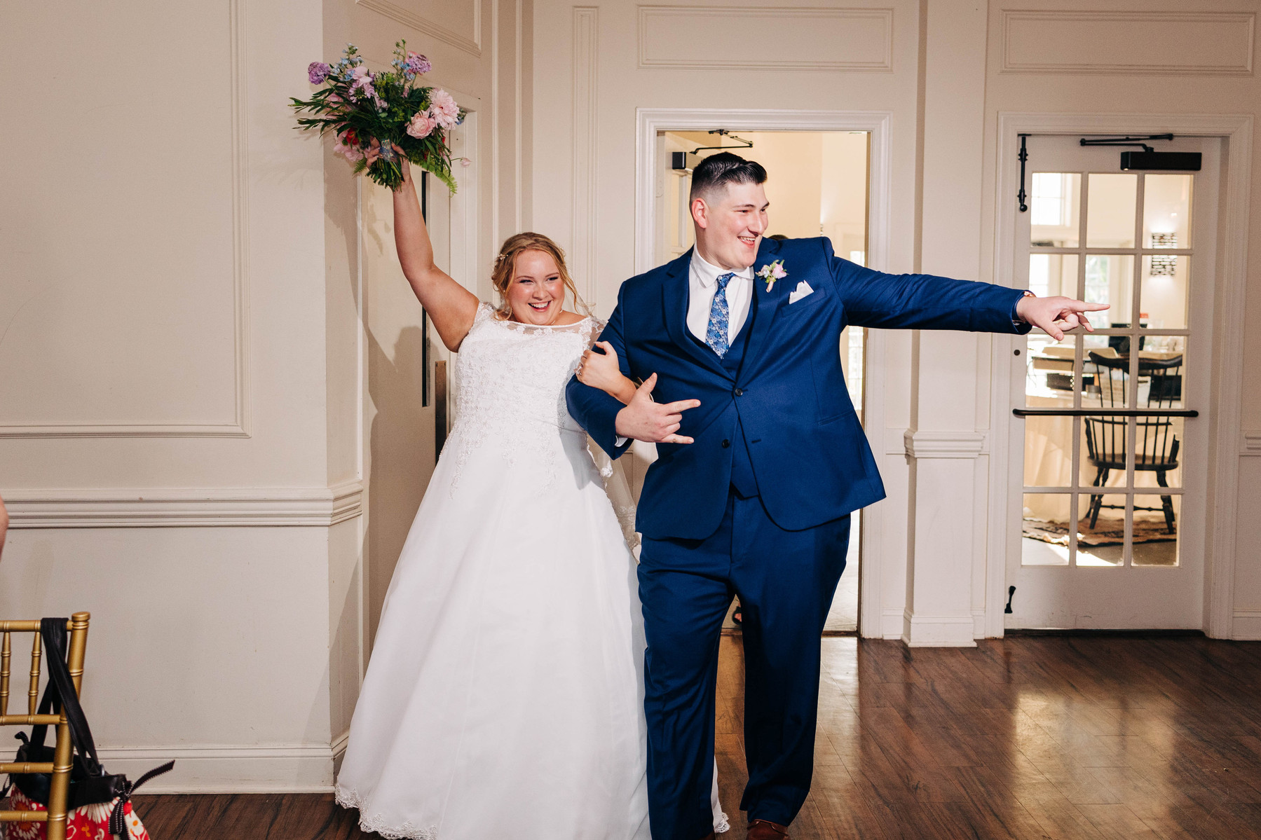 bride and groom entrance after being introduced at their wedding reception at the farmhouse at people's light theater in malvern pennsylvania