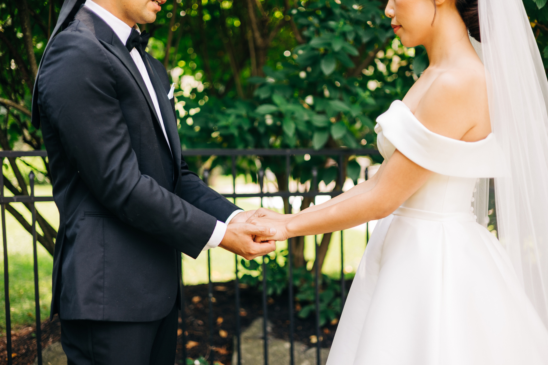 bride and groom hold hands while praying before their wedding ceremony