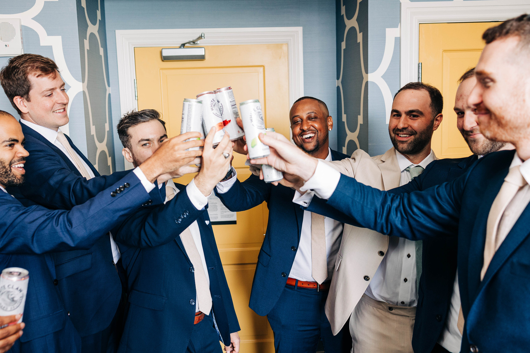 group photo of groomsmen doing a toast at hotel monaco philadelphia