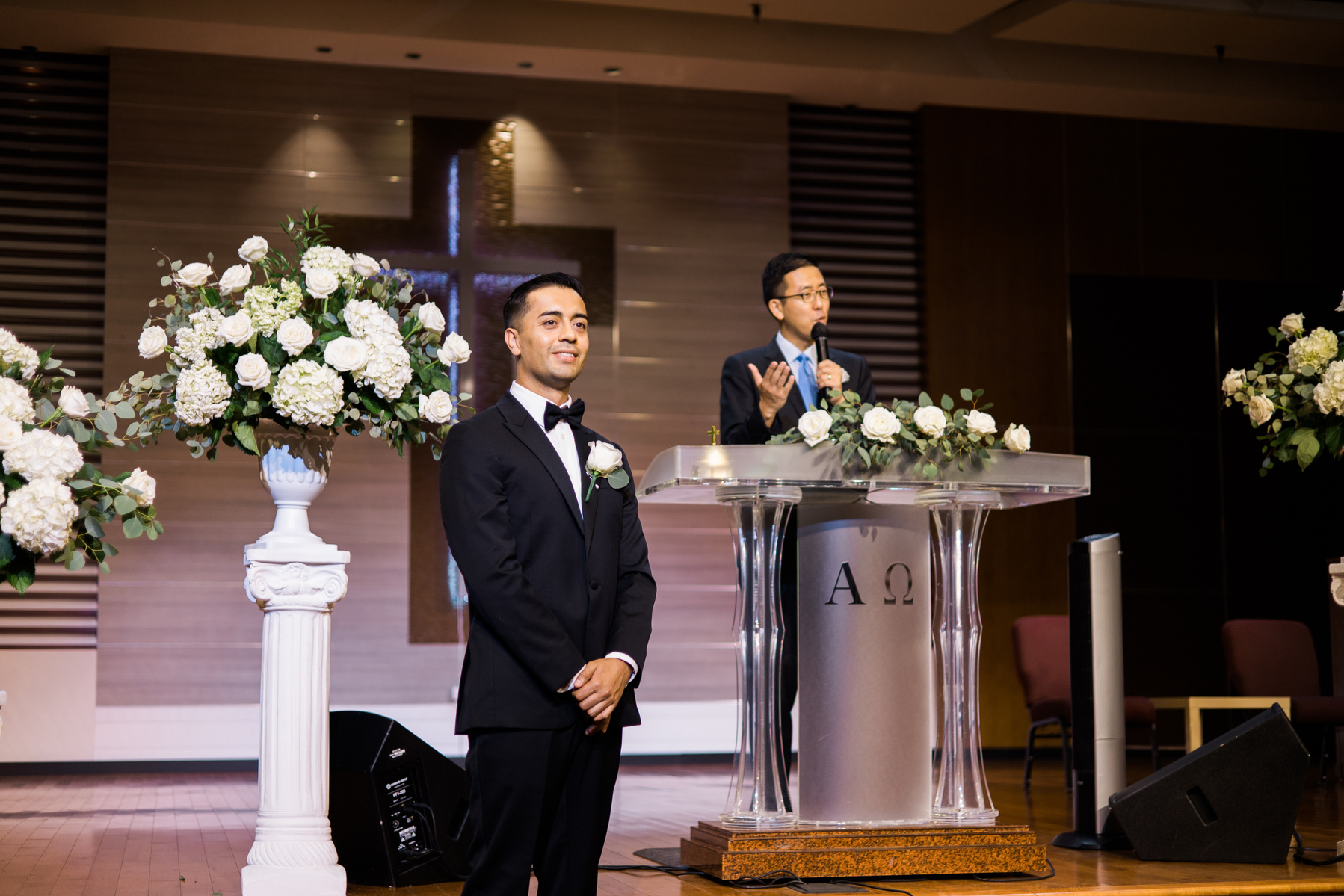 groom stands at the altar on his wedding day waiting to see his bride for the first time