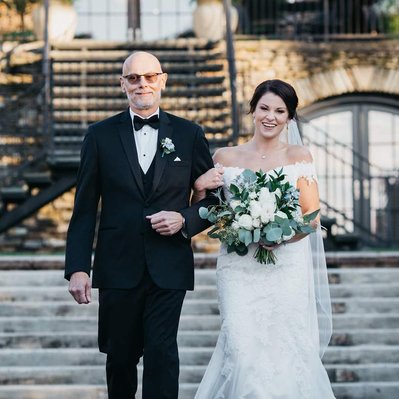 bride walking down aisle with dad at the lake house inn wedding