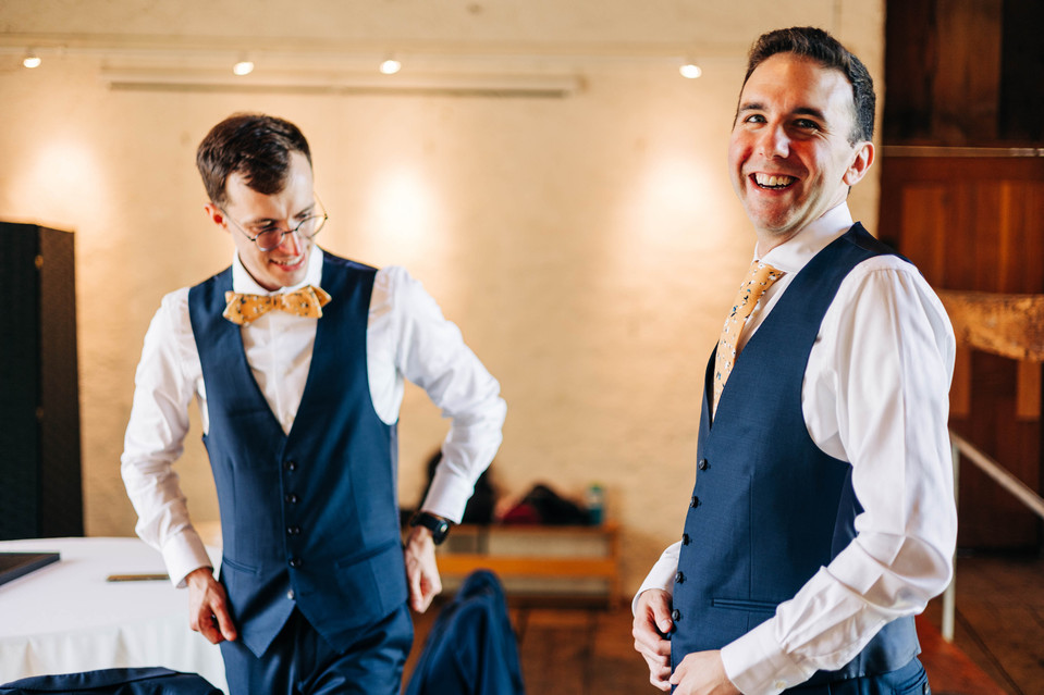 two grooms getting ready together on their wedding day in the suite at bartram's garden in philadelphia