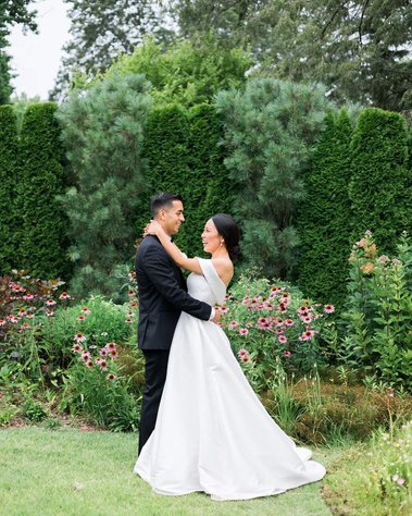 chic bride and groom in a colorful summer garden at stoneleigh gardens