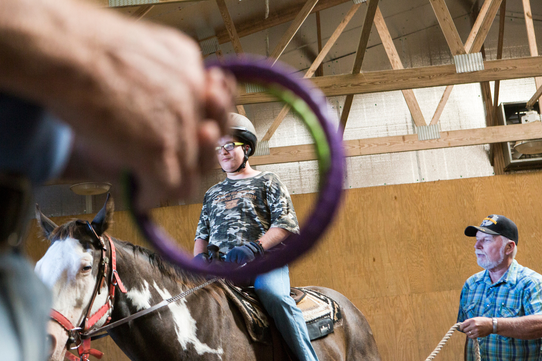 Jerry Hornberger assists Rick Schemel during a ring therapy session with student Danny Huber.
